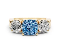 Fancy Blue Cushion Cut Diamond Three-Stone Ring Set in Yellow gold with Round Side Stones and Classic Band