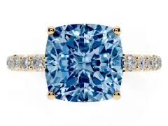 Fancy Blue Cushion Cut Diamond Solitaire Engagement Ring Set in Yellow gold with Round Pavé Band and Prong Setting