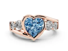 Fancy Blue Heart Cut Diamond Bezel Bypass Ring Set in Rose gold with Round Accents