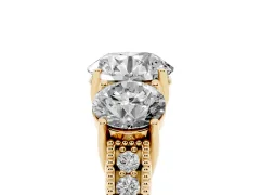 Round Cut Diamond Three-Stone Engagement Ring Set in Yellow gold with Milgrain Pavé Band