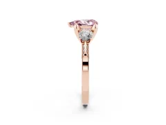 Fancy Pink Pear Cut Diamond Three-Stone Ring Set in Rose gold with Pavé Band and Smaller Side Stones