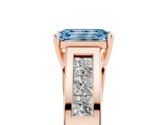 Fancy Blue Emerald Cut Diamond Solitaire Ring Set in Rose gold with Channel-Set Accent Stones and Prong Setting