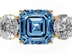Fancy Blue Asscher Cut Diamond Three-Stone Ring Set in Yellow gold with Round Side Stones and Classic Band
