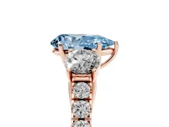 Fancy Blue Pear Cut Diamond Three-Stone Ring Set in Rose gold with Round Side Stones and Delicate Pavé Band