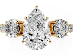 Pear Cut Diamond Three-Stone Ring Set in Yellow gold with Round Side Stones and Delicate Pavé Band