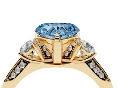 Fancy Blue Heart Cut Diamond Three-Stone Ring Set in Yellow gold with Pavé Band and Smaller Side Stones