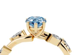 Fancy Blue Pear Cut Diamond Solitaire Ring Set in Yellow gold with Twisted Marquise Accent Band