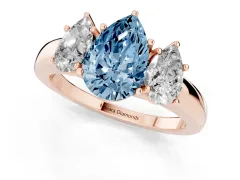 Fancy Blue Pear Cut Diamond Three-Stone Ring Set in Rose gold with Bold Center and Classic Band