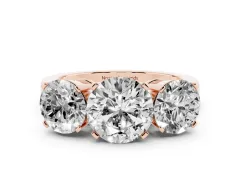 Round Cut Diamond Three-Stone Ring Set in Rose gold with Channel-Set Band and Prong Settings