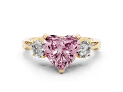 Fancy Pink Heart Cut Diamond Three-Stone Ring Set in Yellow gold with Pavé Band and Smaller Side Stones