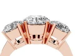 Round Cut Diamond Three-Stone Ring Set in Rose gold with Channel-Set Band and Prong Settings