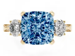 Fancy Blue Cushion Cut Diamond Three-Stone Ring Set in Yellow gold with Pavé Band and Smaller Side Stones