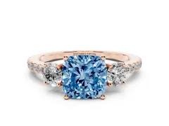Fancy Blue Cushion Cut Diamond Three-Stone Ring Set in Rose gold with Pavé Band and Graduated Sides