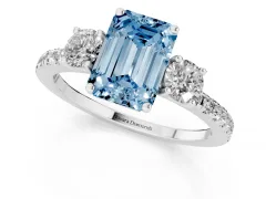 Fancy Blue Emerald Cut Diamond Three-Stone Ring Set in White gold with Pavé Band and Graduated Sides