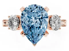 Fancy Blue Pear Cut Diamond Three-Stone Ring Set in Rose gold with Pavé Band and Smaller Side Stones