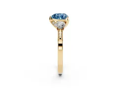 Fancy Blue Heart Cut Diamond Three-Stone Ring Set in Yellow gold with Pavé Band and Smaller Side Stones