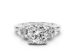 Cushion Cut Diamond Three-Stone Ring Set in Platinum with Pavé Band and Smaller Side Stones