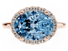 Fancy Blue Oval Cut Diamond Halo Engagement Ring Set in Rose gold with Pavé Band and Rising Shoulders