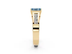 Fancy Blue Emerald Cut Diamond Solitaire Ring Set in Yellow gold with Channel-Set Accent Stones and Prong Setting