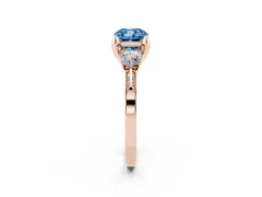 Fancy Blue Cushion Cut Diamond Three-Stone Ring Set in Rose gold with Pavé Band and Smaller Side Stones