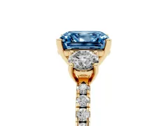 Fancy Blue Asscher Cut Diamond Three-Stone Ring Set in Yellow gold with Pavé Band and Graduated Sides
