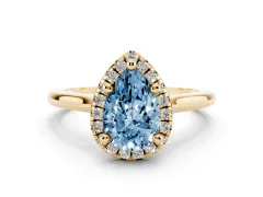 Fancy Blue Pear Cut Diamond Halo Engagement Ring Set in Yellow gold with Pavé Band and Rising Shoulders