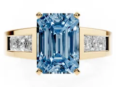 Fancy Blue Emerald Cut Diamond Solitaire Ring Set in Yellow gold with Channel-Set Accent Stones and Prong Setting