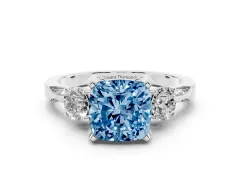 Fancy Blue Cushion Cut Diamond Three-Stone Ring Set in Platinum with Pavé Band and Smaller Side Stones