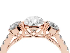 Pear Cut Diamond Three-Stone Ring Set in Rose gold with Round Side Stones and Delicate Pavé Band