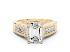 Emerald Cut Diamond Solitaire Ring Set in Yellow gold with Channel-Set Accent Stones and Prong Setting