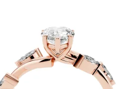 Pear Cut Diamond Solitaire Ring Set in Rose gold with Twisted Marquise Accent Band