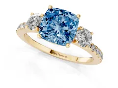 Fancy Blue Cushion Cut Diamond Three-Stone Ring Set in Yellow gold with Pavé Band and Graduated Sides