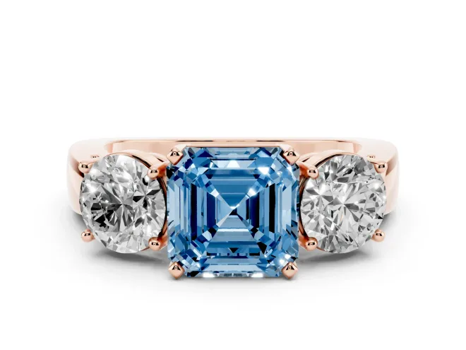 Fancy Blue Asscher Cut Diamond Three-Stone Ring Set in Rose gold with Round Side Stones and Classic Band