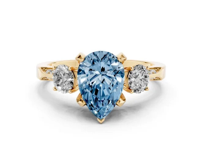 Fancy Blue Pear Cut Diamond Three-Stone Ring Set in Yellow gold with Pavé Band and Smaller Side Stones