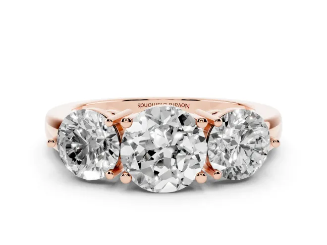 Round Cut Diamond Three-Stone Ring Set in Rose gold with Prong Setting and Plain Band