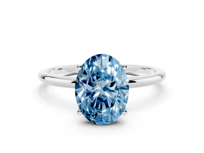 Fancy Blue Oval Cut Diamond Solitaire Engagement Ring Set in Platinum with Thin Band and Prong Setting