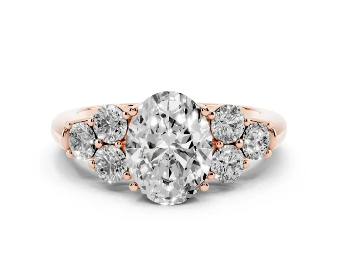 Oval Cut Diamond Cluster Ring Set in Rose gold with Round Accent Stones and Prong Setting on a Plain Band