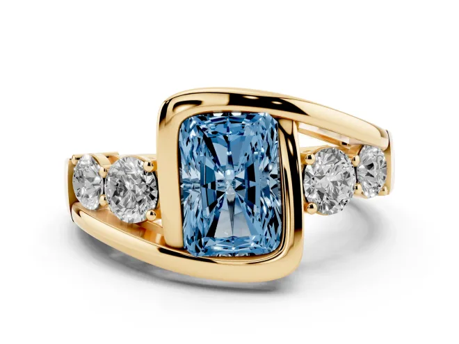 Fancy Blue Radiant Cut Diamond Bezel Bypass Ring Set in Yellow gold with Round Accents
