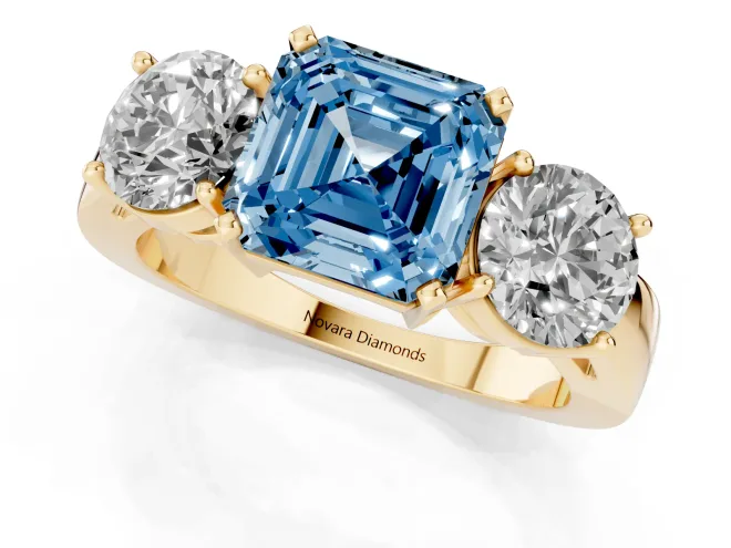 Fancy Blue Asscher Cut Diamond Three-Stone Ring Set in Yellow gold with Round Side Stones and Classic Band – second view