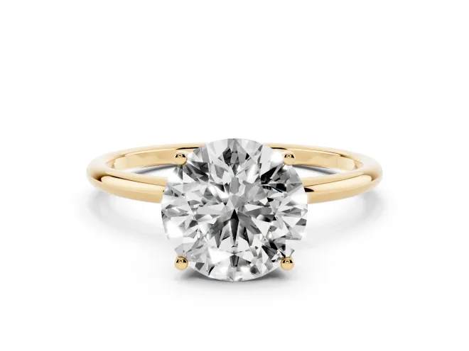 Round Cut Diamond Solitaire Engagement Ring Set in Yellow gold with Thin Band and Prong Setting