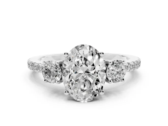 Oval Cut Diamond Three-Stone Ring Set in White gold with Pavé Band and Graduated Sides