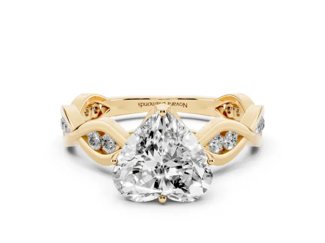 Heart Cut Diamond Twist Band Solitaire Ring Set in Yellow gold with Leaf Prong Setting and Accent Stones