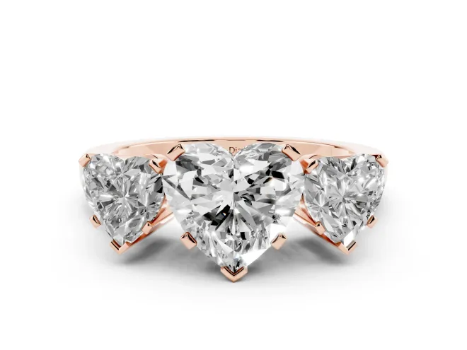 Heart Cut Diamond Three-Stone Ring Set in Rose gold with Channel-Set Band and Prong Settings