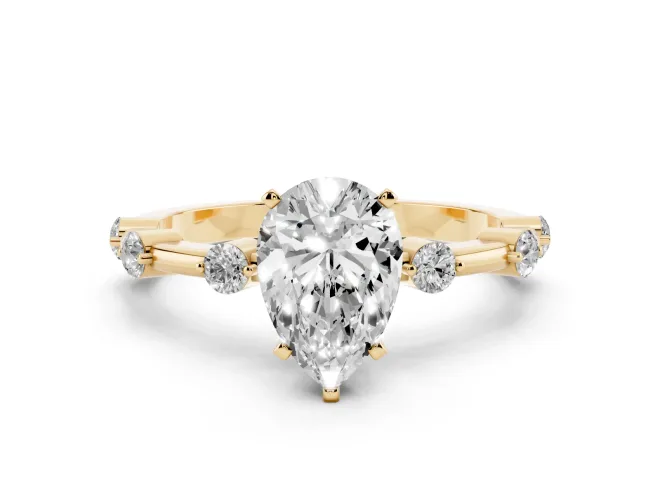 Pear Cut Diamond Solitaire Ring Set in Yellow gold with Bezel Set Side Stones and Prong Setting