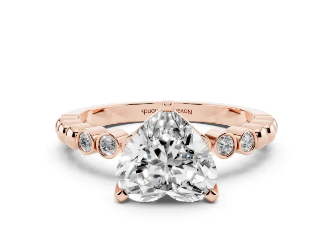 Heart Cut Diamond Solitaire Engagement Ring Set in Rose gold with Bezel Accents on Beaded Band