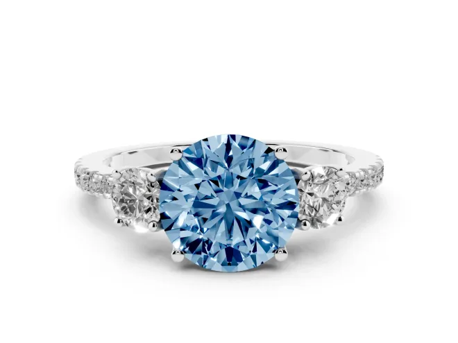 Fancy Blue Round Cut Diamond Three-Stone Ring Set in White gold with Pavé Band and Graduated Sides