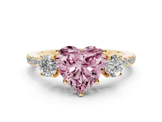 Fancy Pink Heart Cut Diamond Three-Stone Ring Set in Yellow gold with Pavé Band and Graduated Sides