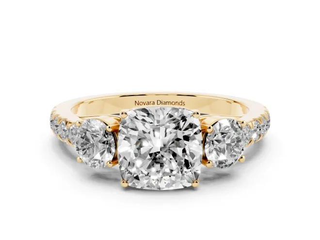 Cushion Cut Diamond Three-Stone Ring Set in Yellow gold with Round Side Stones and Delicate Pavé Band
