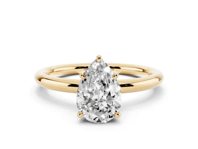 Pear Cut Diamond Solitaire Ring Set in Yellow gold with Thin Band and Prong Setting