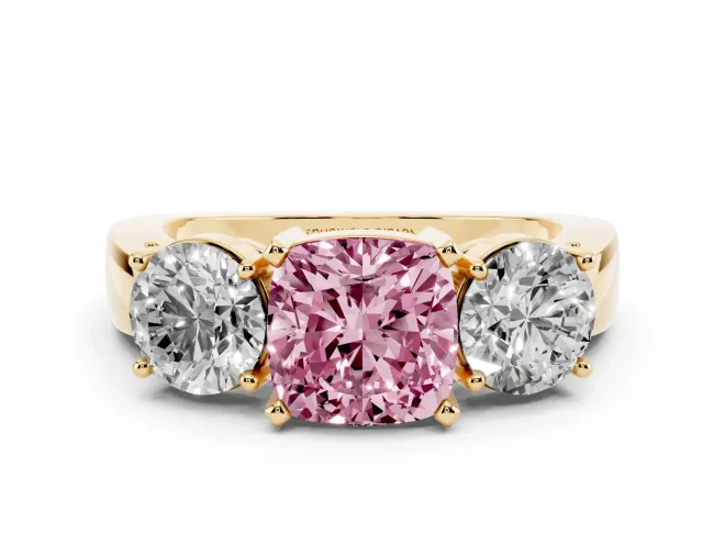 Fancy Pink Cushion Cut Diamond Three-Stone Ring Set in Yellow gold with Round Side Stones and Classic Band